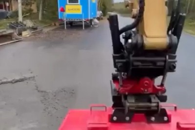 Excavator Sweeping Road with Brush Attachment: Efficient Street Cleaning in Action